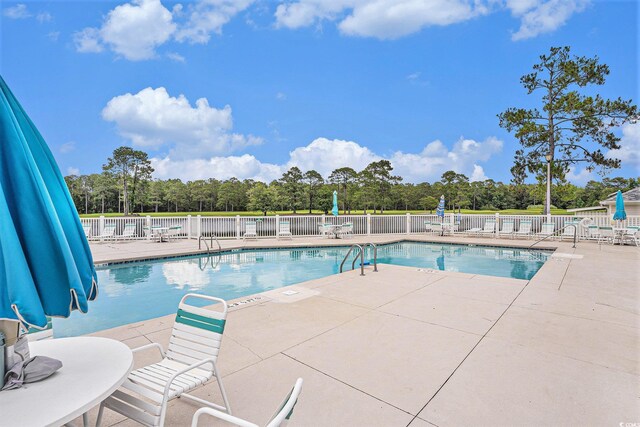4726 Southern Trl, Myrtle Beach, SC 29579 - community pool with a patio area and view of wooded area