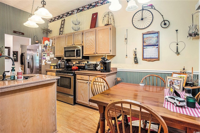 4726 Southern Trl, Myrtle Beach, SC 29579 - kitchen with appliances with stainless steel finishes, light brown cabinets, light countertops, a chandelier, and light wood-style floors
