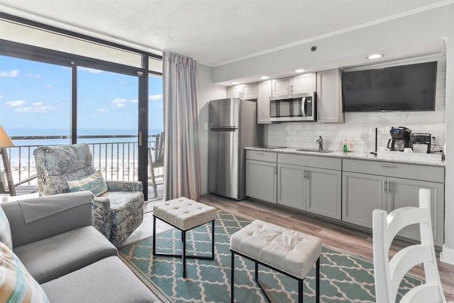 4800 S Ocean Blvd Unit 520, North Myrtle Beach, SC 29582 - living room with plenty of natural light, ornamental molding, wood finished floors, and floor to ceiling windows