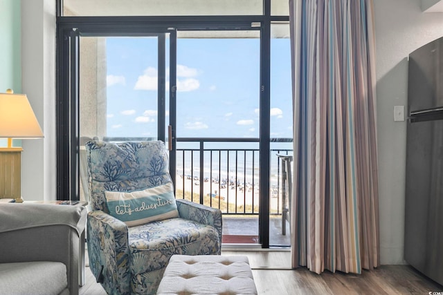 4800 S Ocean Blvd Unit 520, North Myrtle Beach, SC 29582 - living area with wood finished floors, a water view, and healthy amount of natural light