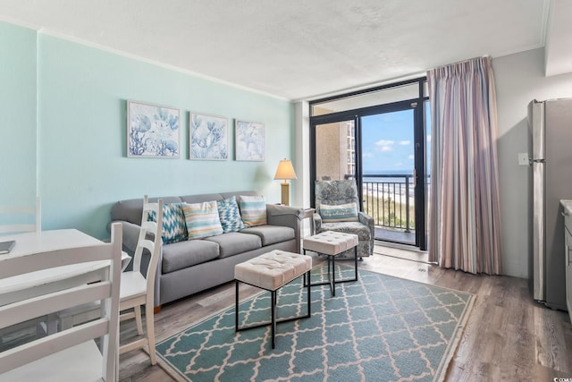 4800 S Ocean Blvd Unit 520, North Myrtle Beach, SC 29582 - living area featuring floor to ceiling windows, wood finished floors, and ornamental molding