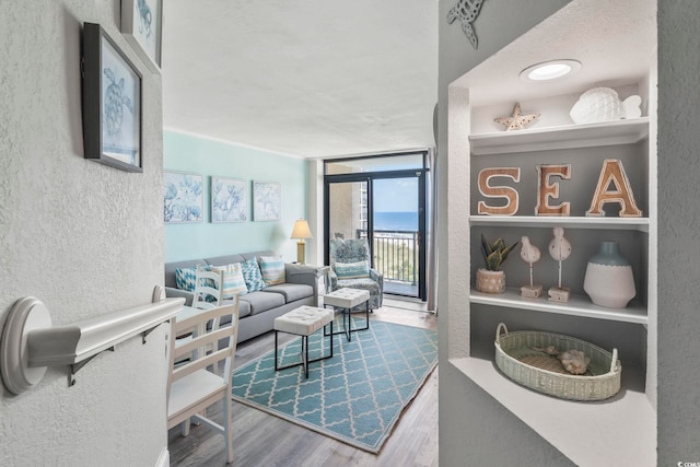 4800 S Ocean Blvd Unit 520, North Myrtle Beach, SC 29582 - living room with a textured wall, wood finished floors, and a wall of windows