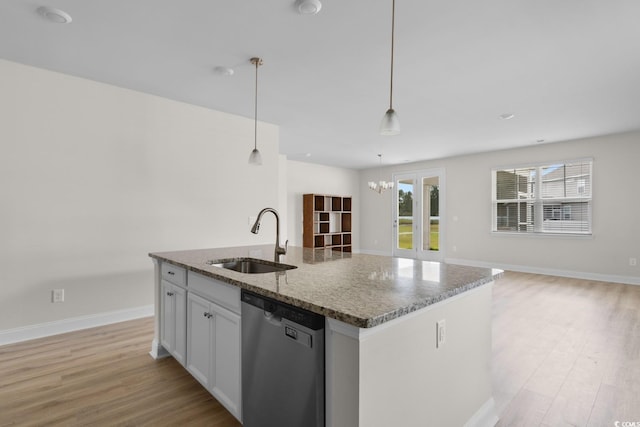 490 Calhoun Falls Dr, Myrtle Beach, SC 29579 - kitchen featuring stainless steel dishwasher, light wood-style floors, a kitchen island with sink, stone counters, and open floor plan