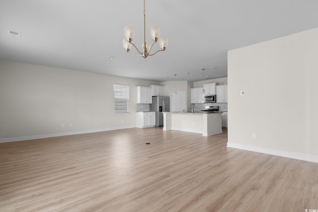 490 Calhoun Falls Dr, Myrtle Beach, SC 29579 - unfurnished living room featuring a chandelier and light wood finished floors