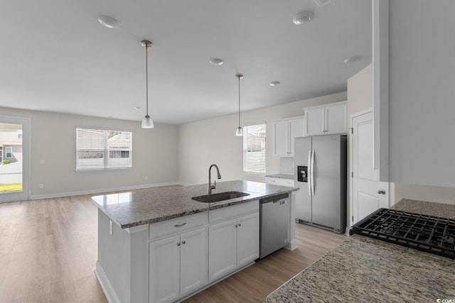 490 Calhoun Falls Dr, Myrtle Beach, SC 29579 - kitchen featuring appliances with stainless steel finishes, plenty of natural light, light wood-style floors, and light stone counters