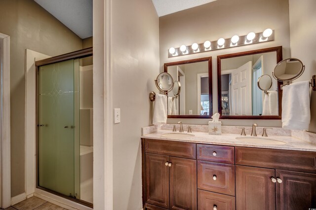 1010 Swan Lake Dr, North Myrtle Beach, SC 29582 - bathroom with a stall shower, double vanity, and tile patterned floors