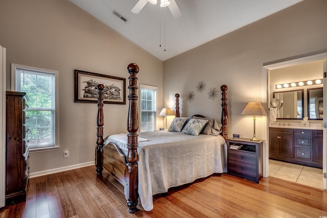 1010 Swan Lake Dr, North Myrtle Beach, SC 29582 - bedroom with light wood finished floors, high vaulted ceiling, connected bathroom, and ceiling fan