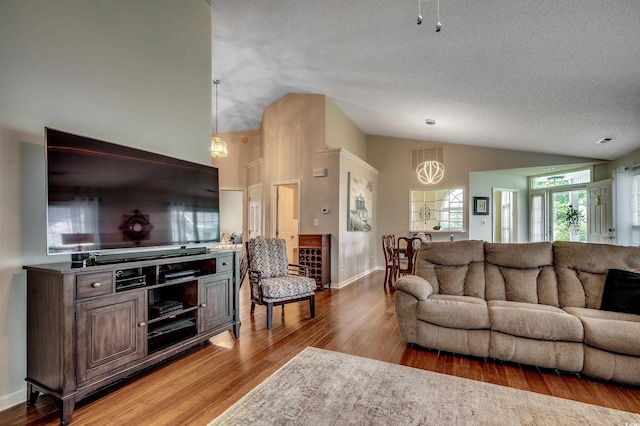 1010 Swan Lake Dr, North Myrtle Beach, SC 29582 - living area featuring a chandelier, light wood finished floors, high vaulted ceiling, and a textured ceiling