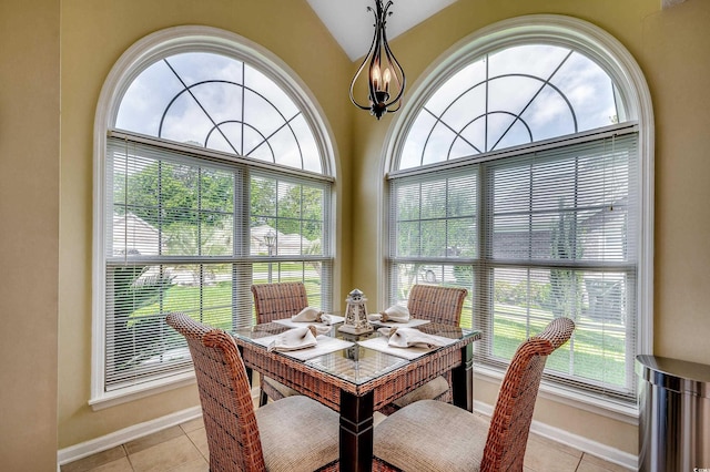 1010 Swan Lake Dr, North Myrtle Beach, SC 29582 - dining area with light tile patterned floors, vaulted ceiling, and a chandelier