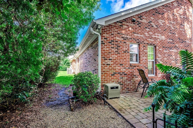 1010 Swan Lake Dr, North Myrtle Beach, SC 29582 - view of side of property featuring brick siding and a patio