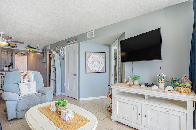 9400 Shore Dr Unit 716, Myrtle Beach, SC 29572 - living room with light tile patterned floors, a textured ceiling, and a ceiling fan