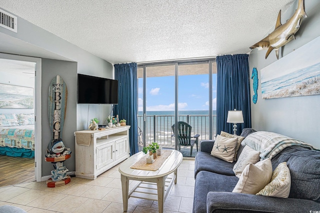 9400 Shore Dr Unit 716, Myrtle Beach, SC 29572 - living room with expansive windows, a textured ceiling, and light tile patterned floors