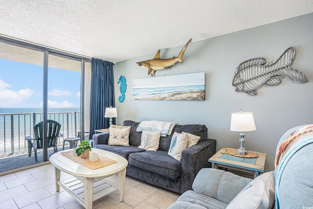 9400 Shore Dr Unit 716, Myrtle Beach, SC 29572 - living area with a wall of windows, a water view, a textured ceiling, and light tile patterned flooring