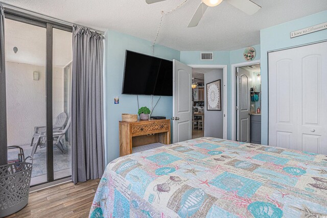 9400 Shore Dr Unit 716, Myrtle Beach, SC 29572 - bedroom with access to exterior, wood finished floors, a ceiling fan, and a textured ceiling