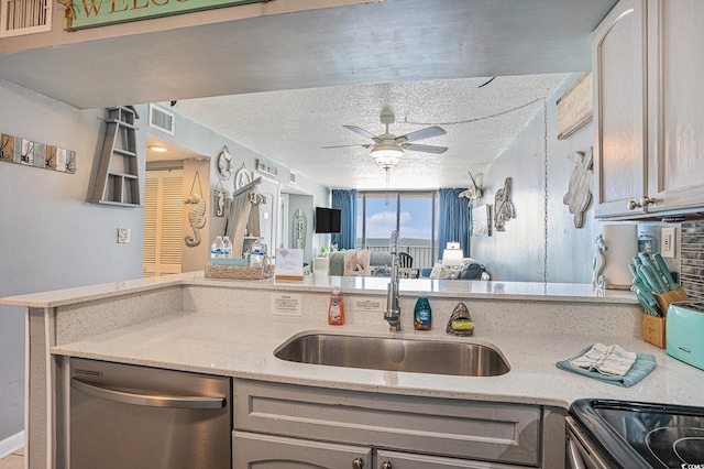 9400 Shore Dr Unit 716, Myrtle Beach, SC 29572 - kitchen with stainless steel dishwasher, ceiling fan, light stone countertops, open floor plan, and a textured ceiling