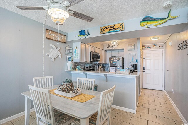 9400 Shore Dr Unit 716, Myrtle Beach, SC 29572 - dining space featuring light tile patterned flooring, a ceiling fan, and a textured ceiling