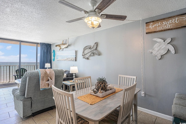 9400 Shore Dr Unit 716, Myrtle Beach, SC 29572 - dining area with a ceiling fan, floor to ceiling windows, a textured ceiling, light tile patterned floors, and a water view