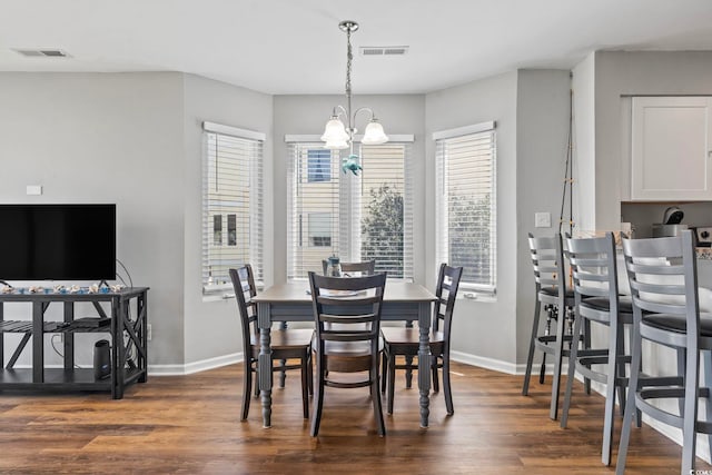 1100 Possum Trot Rd Unit F218, North Myrtle Beach, SC 29582 - dining area featuring dark wood finished floors, plenty of natural light, and a chandelier