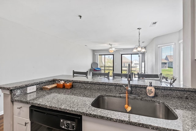 1100 Possum Trot Rd Unit F218, North Myrtle Beach, SC 29582 - kitchen featuring dishwasher, dark stone countertops, a ceiling fan, and hanging light fixtures