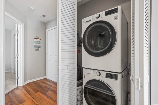 1100 Possum Trot Rd Unit F218, North Myrtle Beach, SC 29582 - laundry area featuring estacked washer and dryer and wood finished floors