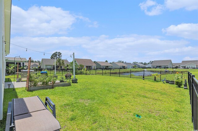 227 Palm Terrace Loop, Conway, SC 29526 - fenced backyard with a residential view, a garden, and a water view