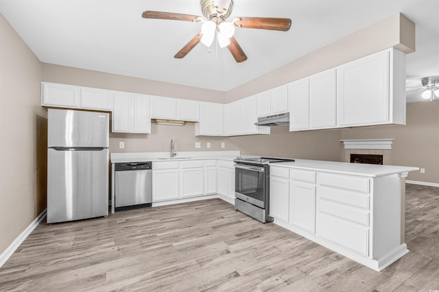 178 Beaver Pond Loop Unit 60, Pawleys Island, SC 29585 - kitchen featuring appliances with stainless steel finishes, under cabinet range hood, ceiling fan, light wood finished floors, and white cabinetry