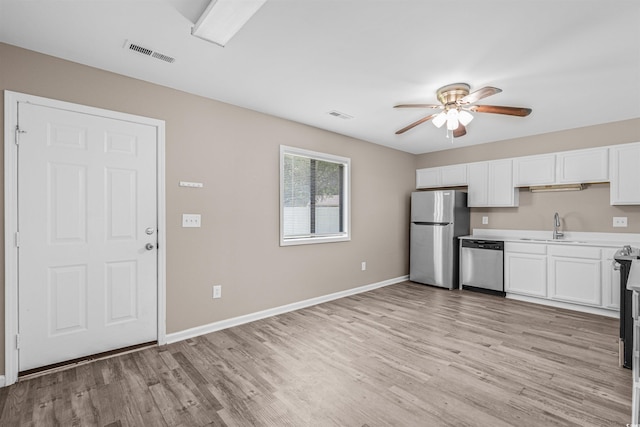 178 Beaver Pond Loop Unit 60, Pawleys Island, SC 29585 - kitchen with stainless steel appliances, ceiling fan, light wood finished floors, and white cabinetry