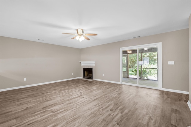 178 Beaver Pond Loop Unit 60, Pawleys Island, SC 29585 - unfurnished living room with ceiling fan, wood finished floors, and a fireplace