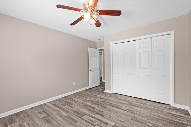 178 Beaver Pond Loop Unit 60, Pawleys Island, SC 29585 - unfurnished bedroom with wood finished floors, a closet, and a ceiling fan