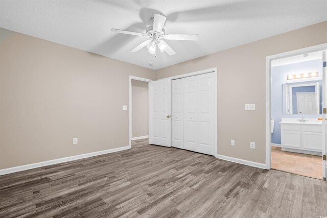 178 Beaver Pond Loop Unit 60, Pawleys Island, SC 29585 - unfurnished bedroom featuring wood finished floors, a closet, connected bathroom, and a ceiling fan