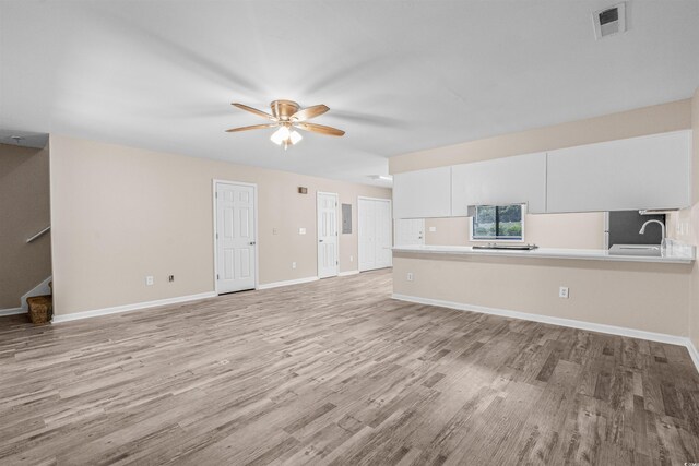 178 Beaver Pond Loop Unit 60, Pawleys Island, SC 29585 - unfurnished living room featuring a ceiling fan, light wood finished floors, and stairway