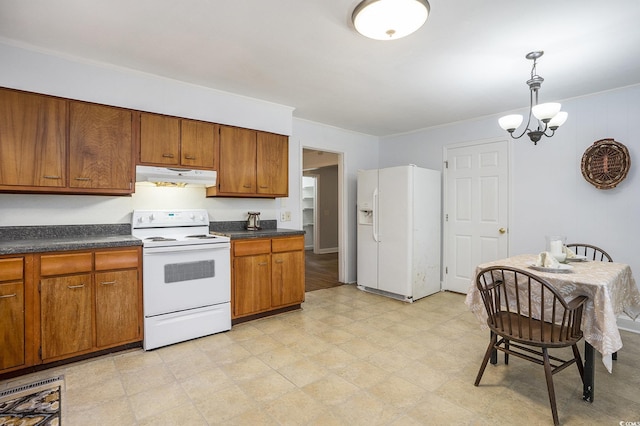 602 3rd Ave N, Myrtle Beach, SC 29577 - kitchen with white appliances, under cabinet range hood, brown cabinetry, dark countertops, and light floors