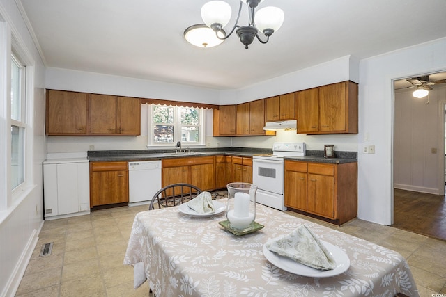 602 3rd Ave N, Myrtle Beach, SC 29577 - kitchen featuring white appliances, brown cabinets, a chandelier, under cabinet range hood, and dark countertops