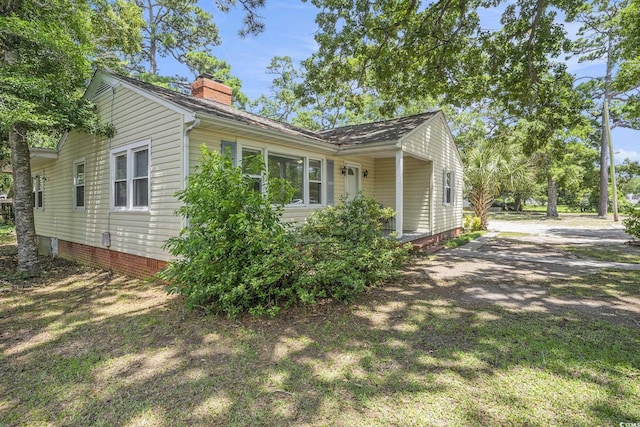 602 3rd Ave N, Myrtle Beach, SC 29577 - view of side of property with a chimney