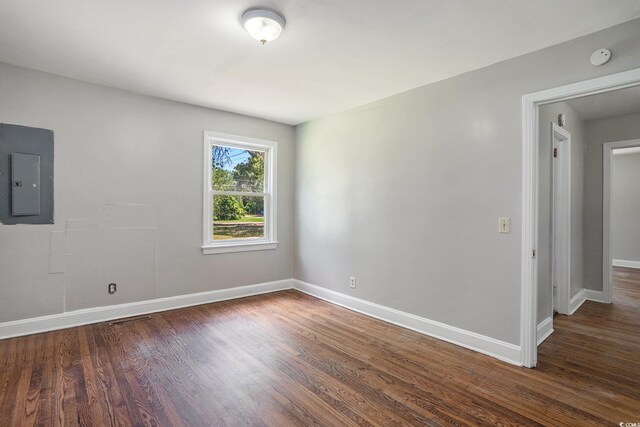 602 3rd Ave N, Myrtle Beach, SC 29577 - unfurnished room featuring electric panel, dark wood finished floors, and a smoke detector