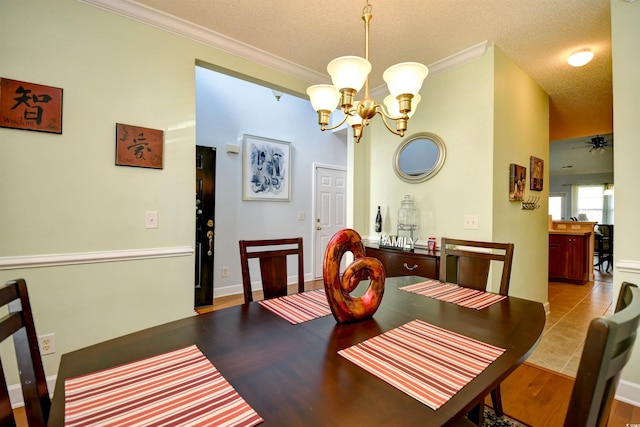 6172 Catalina Dr Unit 113, North Myrtle Beach, SC 29582 - dining room with a chandelier, ornamental molding, a textured ceiling, and wood finished floors