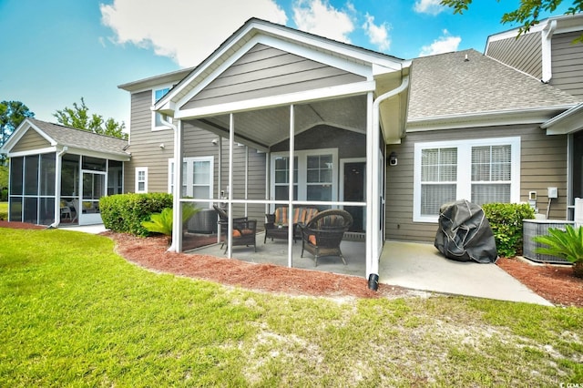 6172 Catalina Dr Unit 113, North Myrtle Beach, SC 29582 - back of property featuring a sunroom, a patio area, a yard, and roof with shingles
