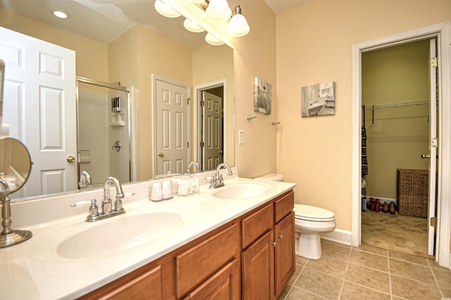 6172 Catalina Dr Unit 113, North Myrtle Beach, SC 29582 - bathroom with double vanity, tiled shower, tile patterned floors, and a spacious closet