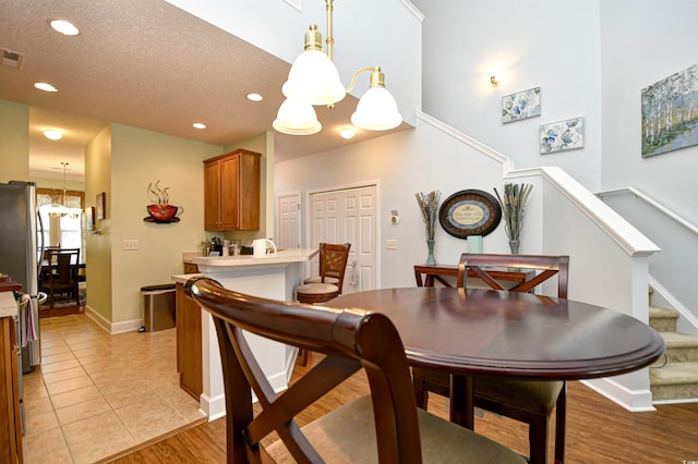 6172 Catalina Dr Unit 113, North Myrtle Beach, SC 29582 - dining area with a chandelier, recessed lighting, stairs, and light wood-style floors