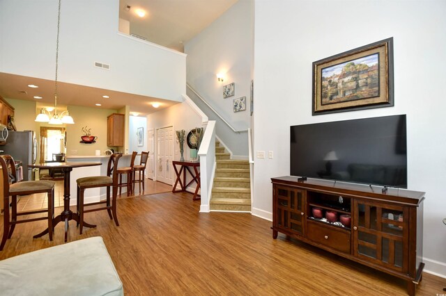 6172 Catalina Dr Unit 113, North Myrtle Beach, SC 29582 - living area featuring stairway, wood finished floors, a towering ceiling, and recessed lighting