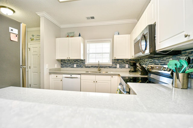 5825 Catalina Dr Unit 833, North Myrtle Beach, SC 29582 - kitchen with appliances with stainless steel finishes, backsplash, light countertops, white cabinets, and ornamental molding