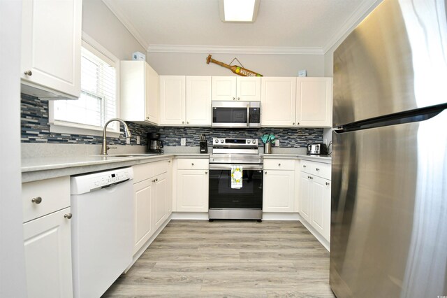 5825 Catalina Dr Unit 833, North Myrtle Beach, SC 29582 - kitchen featuring appliances with stainless steel finishes, crown molding, light countertops, backsplash, and white cabinets