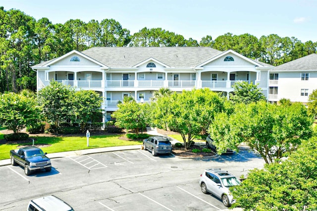 5825 Catalina Dr Unit 833, North Myrtle Beach, SC 29582 - view of building exterior featuring uncovered parking and view of scattered trees