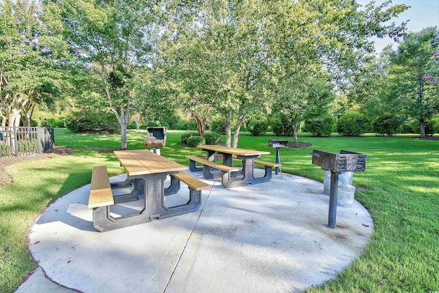 5825 Catalina Dr Unit 833, North Myrtle Beach, SC 29582 - view of community featuring outdoor dining space, a patio area, a lawn, and view of scattered trees