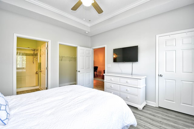 5825 Catalina Dr Unit 833, North Myrtle Beach, SC 29582 - bedroom with ornamental molding, light wood-type flooring, connected bathroom, a closet, and a spacious closet