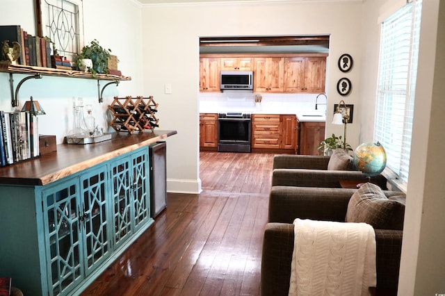 160 Comanche Dr, Georgetown, SC 29440 - kitchen featuring appliances with stainless steel finishes, dark wood-type flooring, crown molding, backsplash, and open shelves