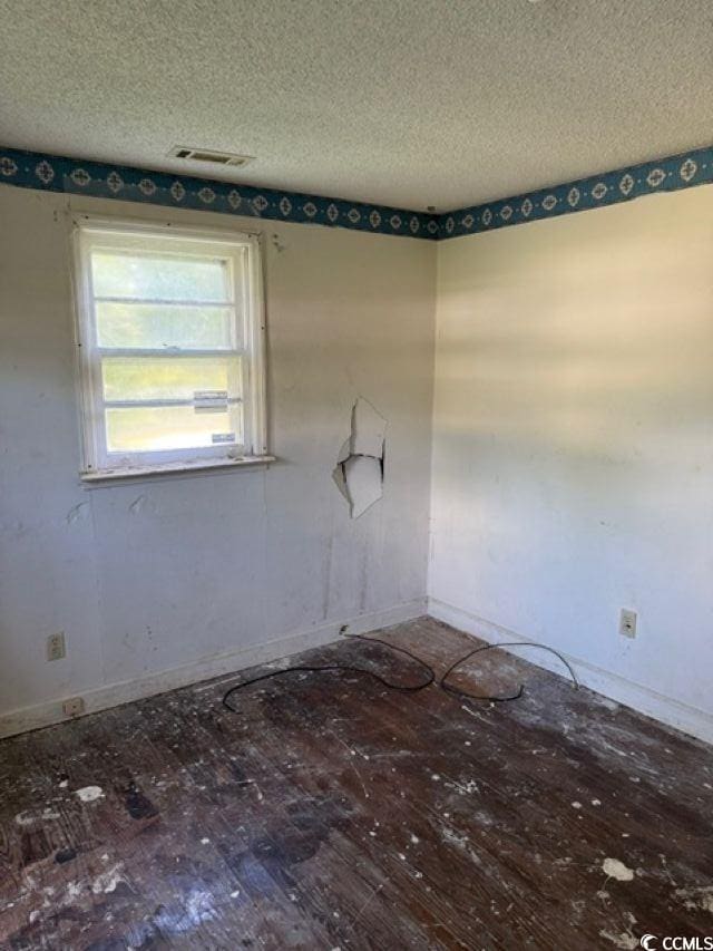 303 Leroy Bethea Rd, Mullins, SC 29574 - unfurnished room featuring a textured ceiling and hardwood / wood-style flooring