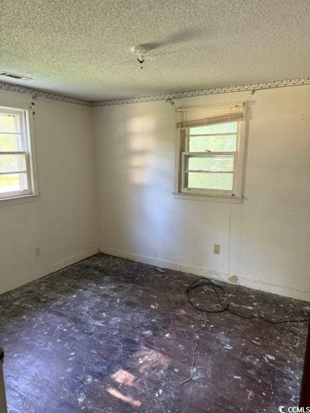 303 Leroy Bethea Rd, Mullins, SC 29574 - spare room featuring a textured ceiling and baseboards