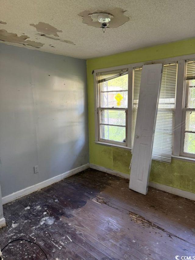 303 Leroy Bethea Rd, Mullins, SC 29574 - empty room featuring a textured ceiling and wood finished floors