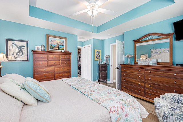 4610 Fringetree Dr, Murrells Inlet, SC 29576 - bedroom with wood finished floors, a closet, a ceiling fan, and a raised ceiling